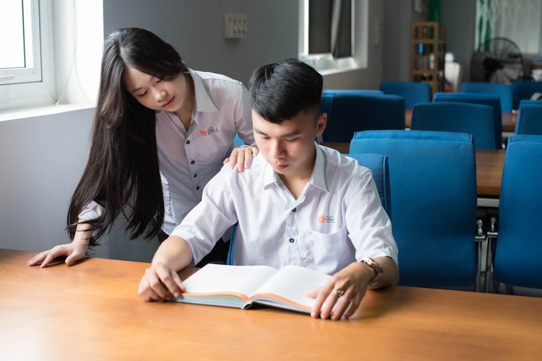 a-person-and-a-boy-looking-at-a-book-us3mwkolpmg